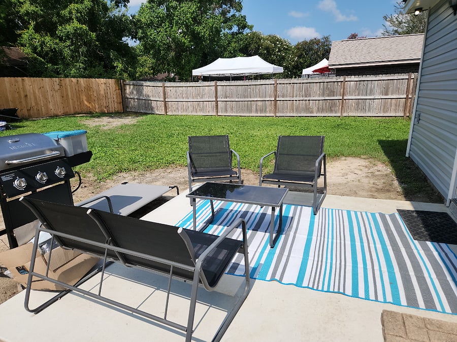 Back patio seating and grill area. Large fenced yard.