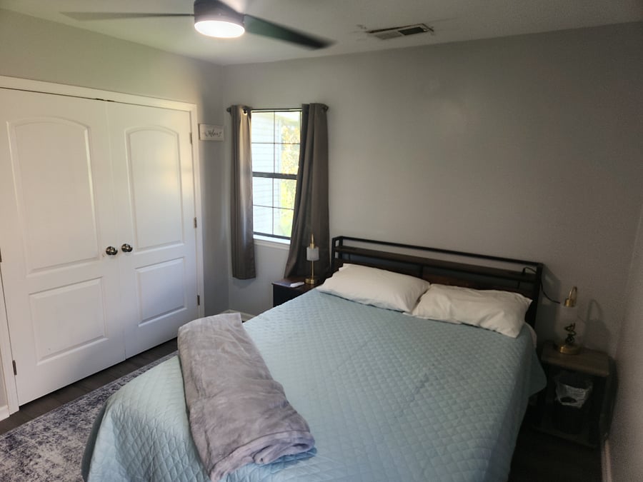 Queen bed, large closet, night stands, dresser and 50" smart tv. Black out pull down shades and curtains provided. Ceiling fan in place. All linens provided.