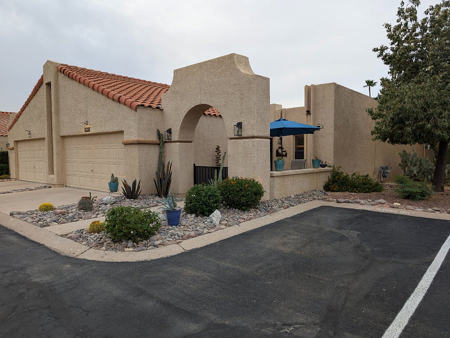 Contemporary landscaping with cactus and artwork. Guest parking next door. Room for one vehicle in garage.