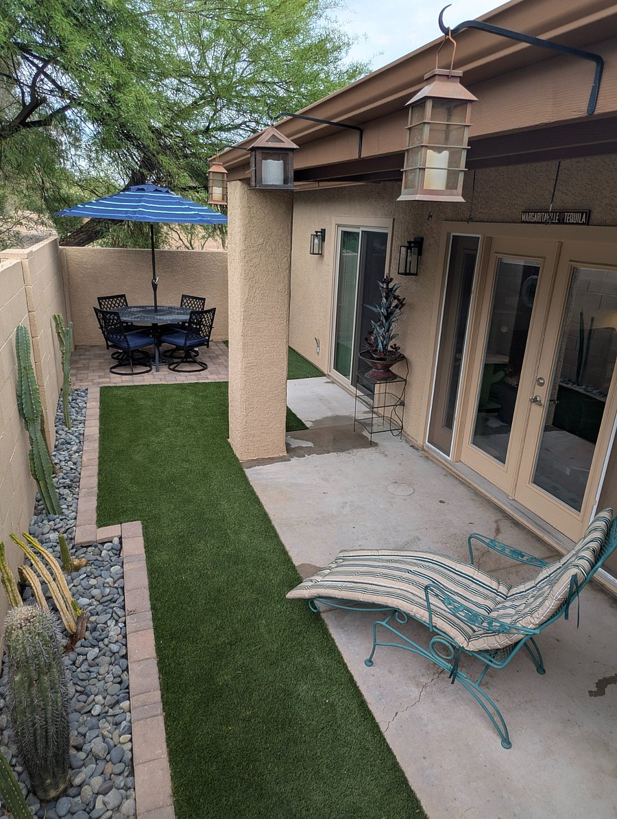 Backyard patio is cozy. Plenty of shade from roof overhang, neighboring trees, and table umbrella. Soothing fountain adds to your relaxation.