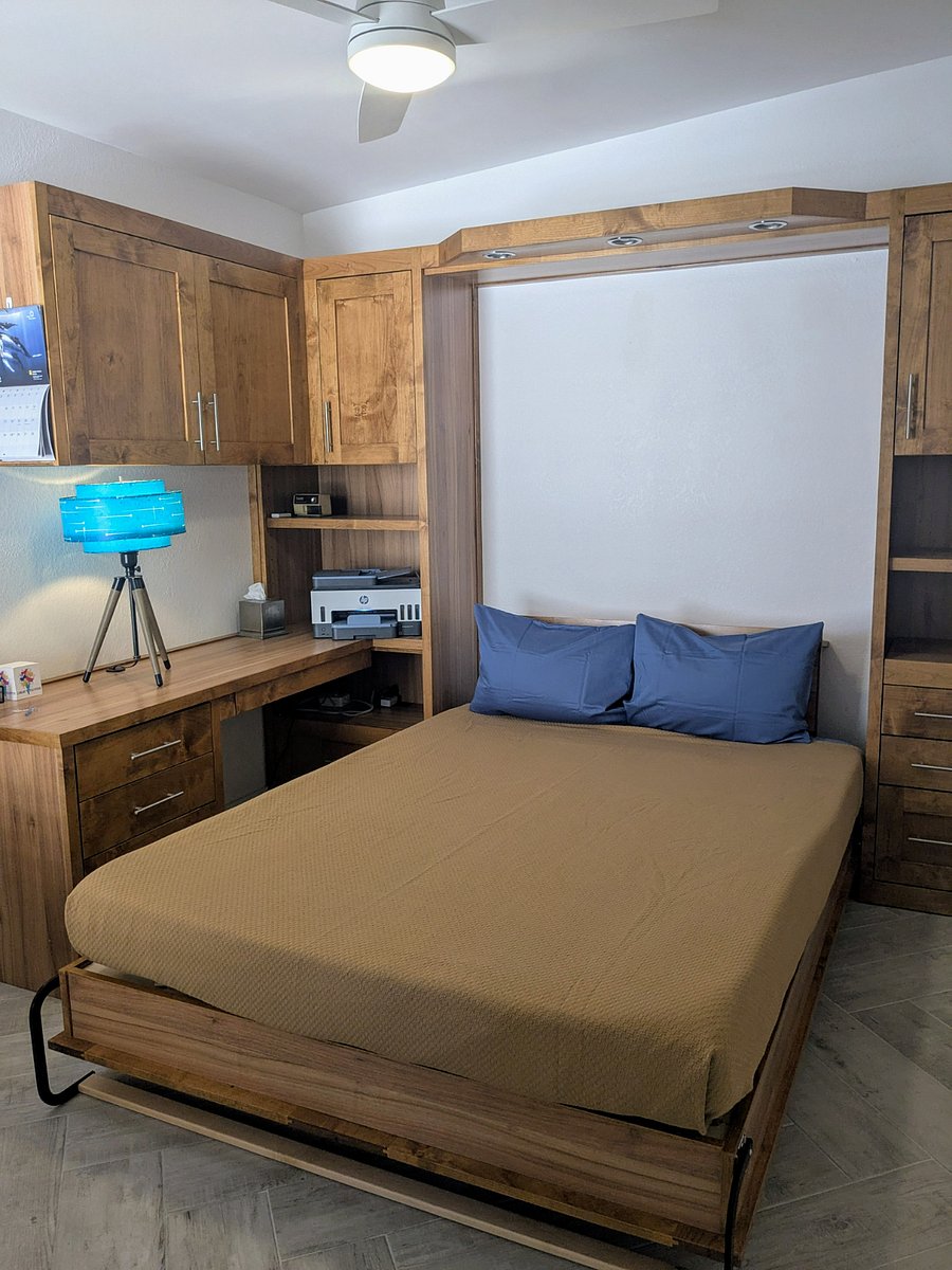 Office bedroom with top quality murphy bed pulled down.