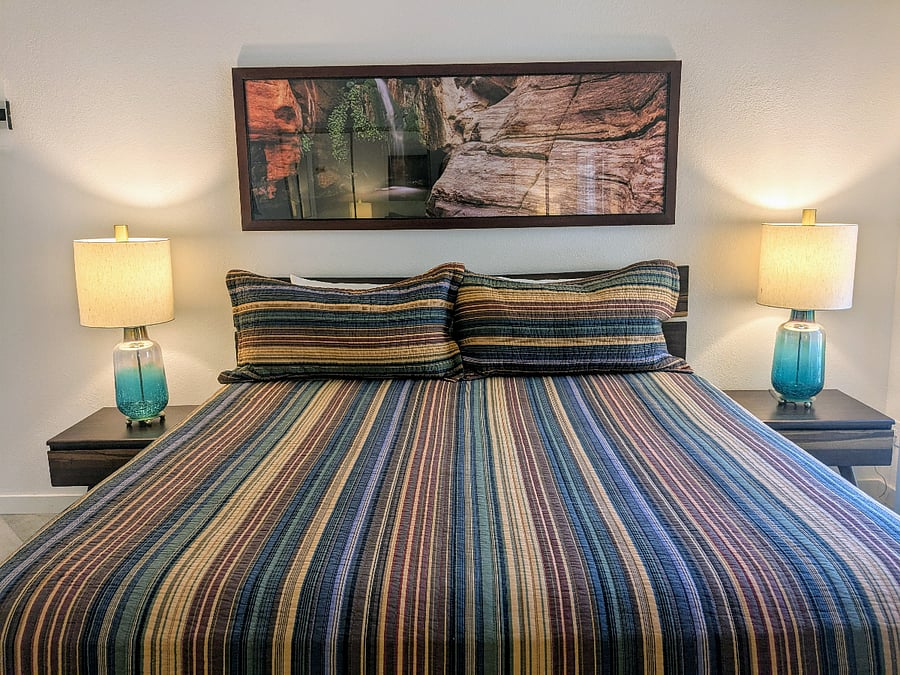 The main bedroom is bright, with sliding door to patio, scandinavian furniture, and beautiful western paintings. Lots of closet space.