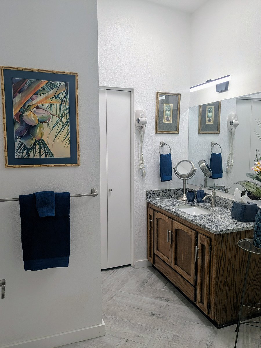 Guest bath has large separate sink area with ample storage for linens and more. Skylight makes it sunny and airy.