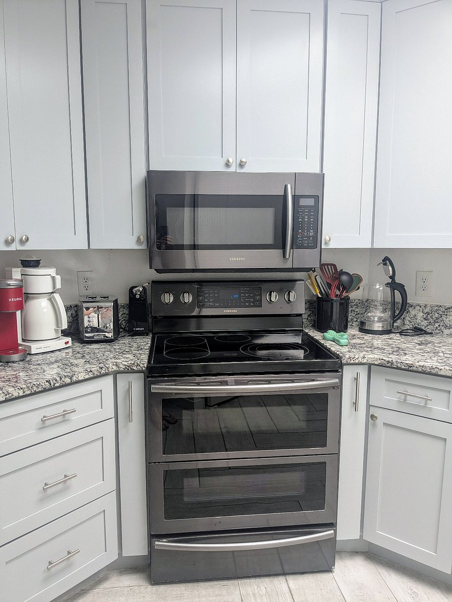 Modern kitchen with split upper/lower oven. Microwave, electric tea kettle, coffee makers, and more.