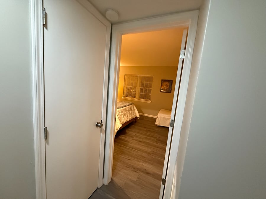 Hallway view into master bedroom.