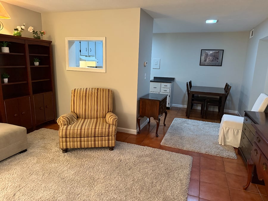Open floorplan seating, bookshelf, and dining area.