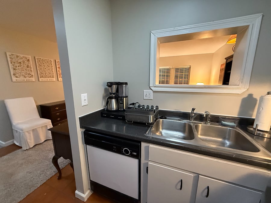 Kitchen features many amenities like coffee maker, blender, silverware, plates, etc.