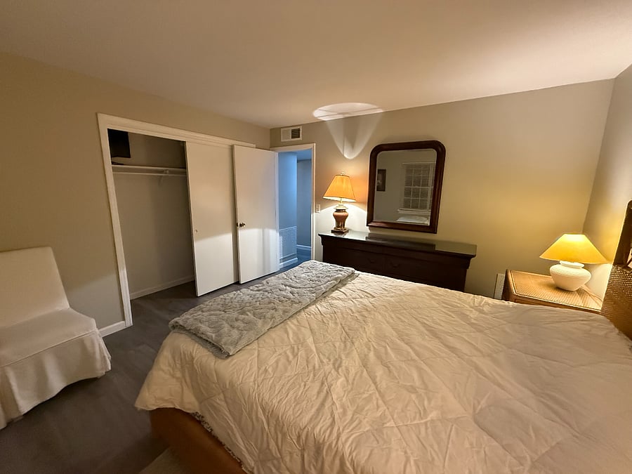 Large sliding door closet for plenty of bedroom clothes hanging and storage.