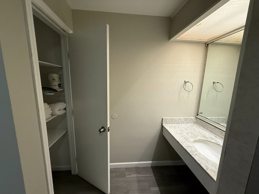 Bathroom has nice linen closet for extra personal storage.