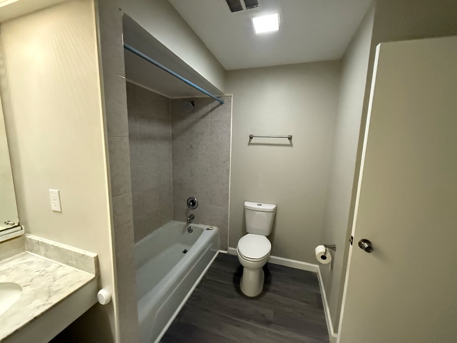 Bathroom in hallway accessible for master bedroom and for living / dining area.