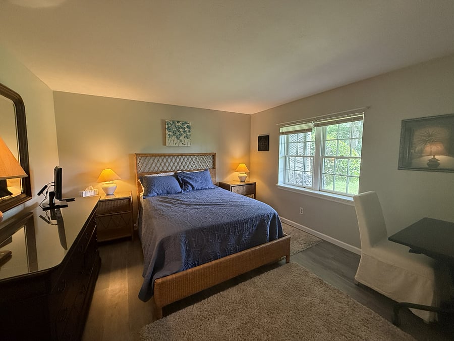 Bedroom features dresser, end tables, and computer desk