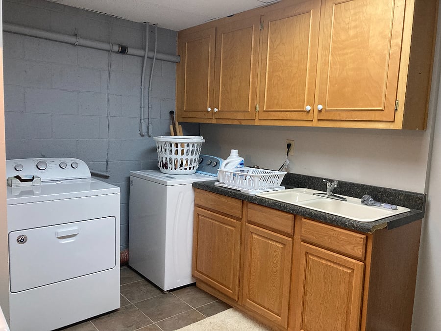 Laundry area with laundry soap supplied.