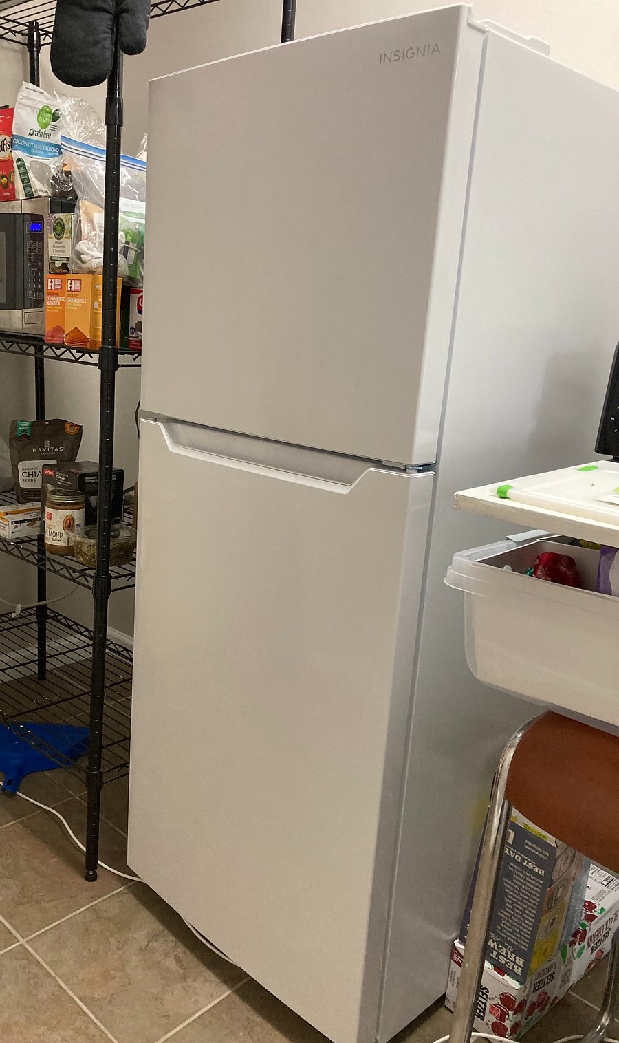 Kitchen has a brand new Insignia fridge and freezer.