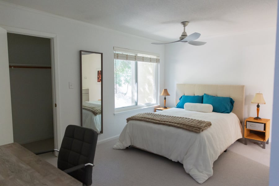 Master bedroom with new queen bed and walk-in closet.