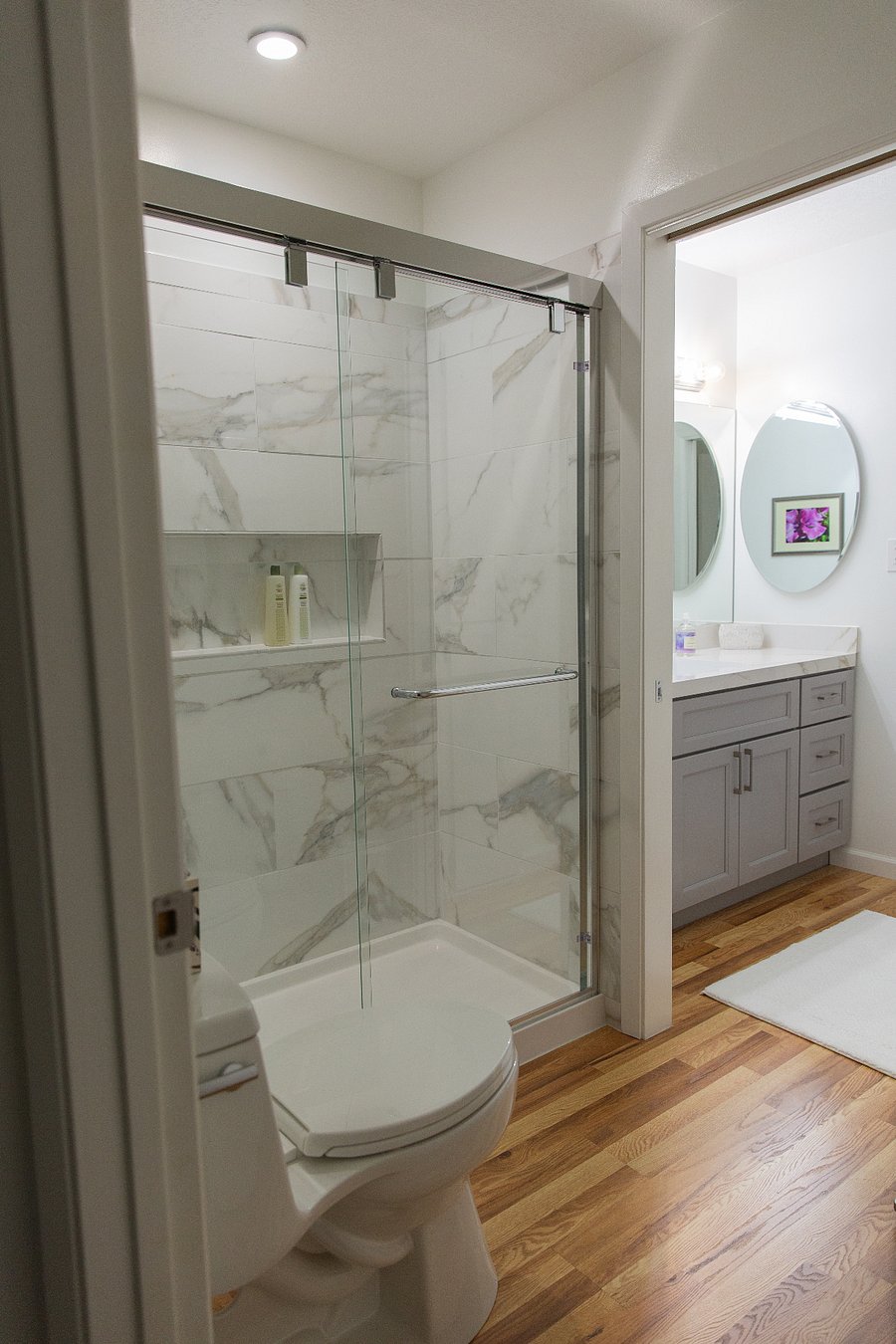 Shower and larger sink and vanity on the right.