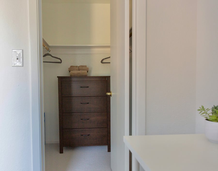Walk in closet with dresser in 2nd bedroom.