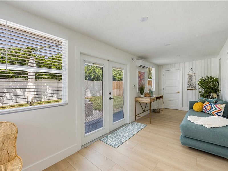 Flexible den space with queen daybed  doubles as office, workout room, or guest suite.