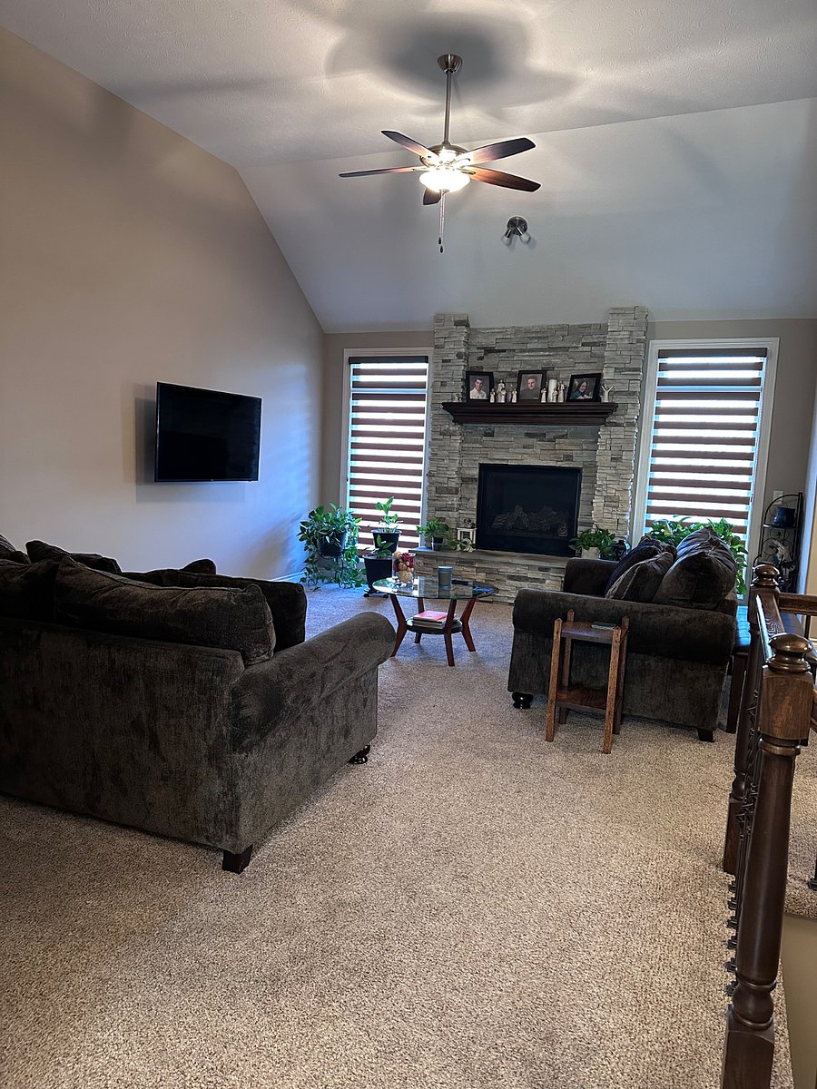 Shared living room space with a gas fireplace.
