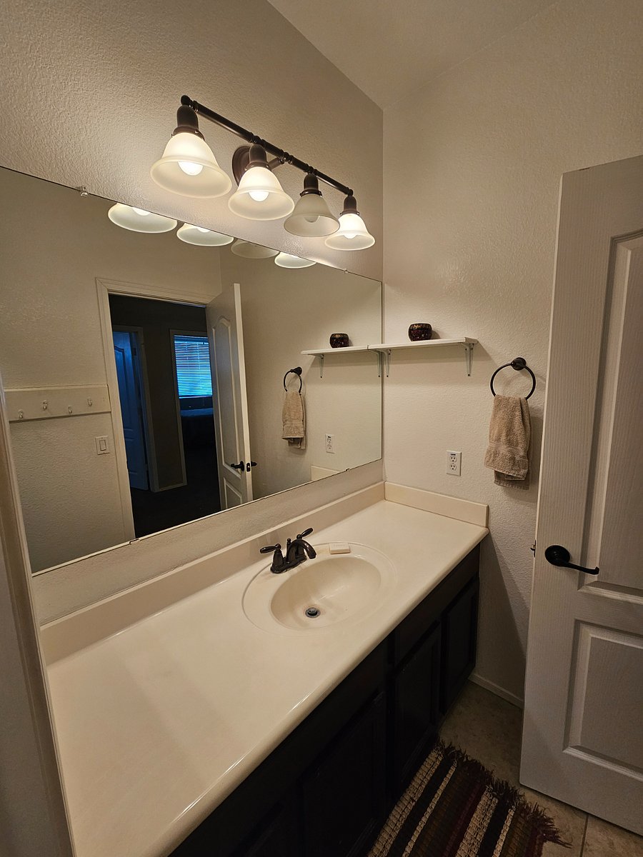 Private bath has ample counter space. Toilet has bidet attachment.