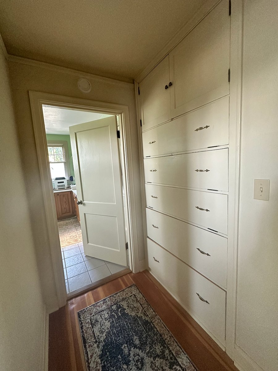 Storage in hall; looking into bathroom