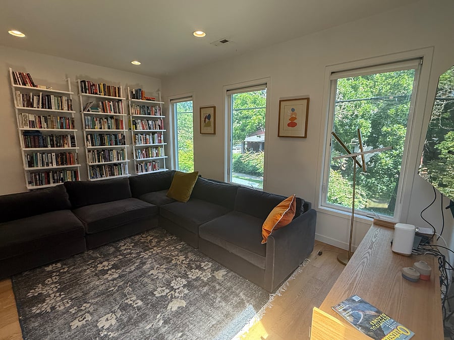 Sun-lit living room, floor-to-ceiling library, 65 4K TV