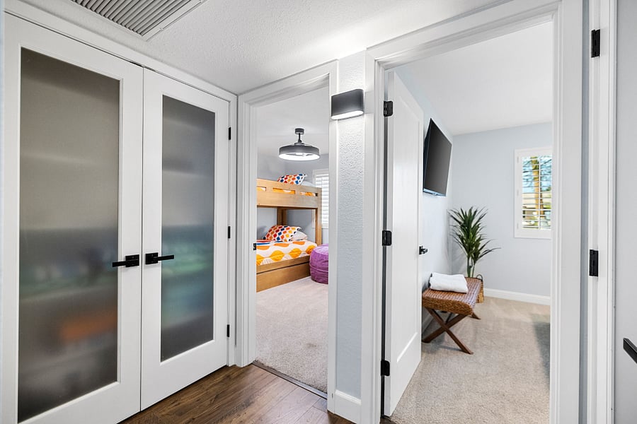 Fun and functional hallway with direct access to a cozy bunk room and a bright guest bedroom  perfect for families or groups.