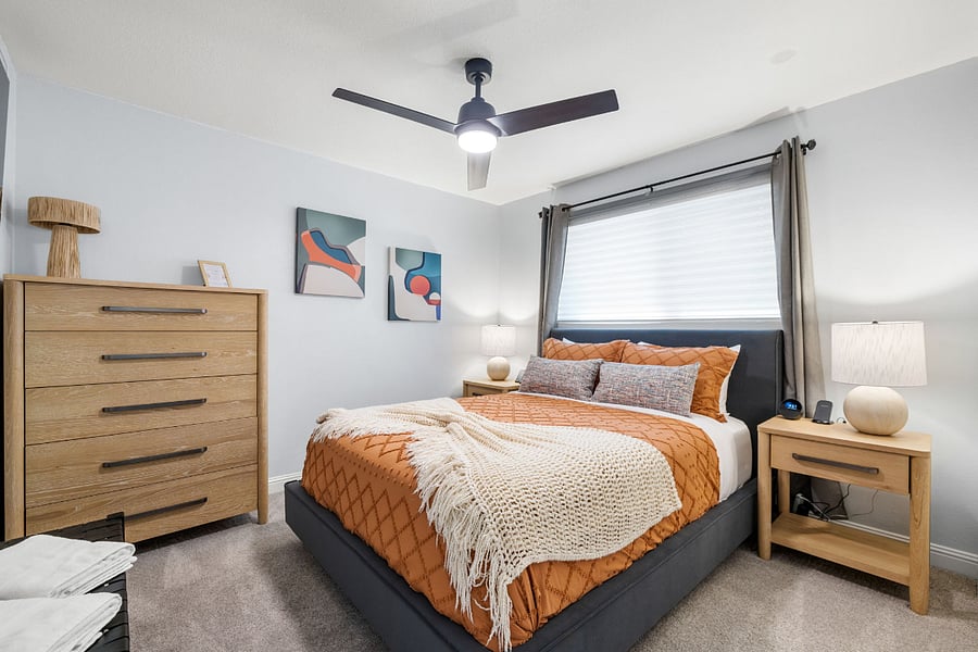 Cozy and contemporary, this bedroom features a plush Queen bed, stylish dcor, and blackout window treatments for a restful night's sleep.