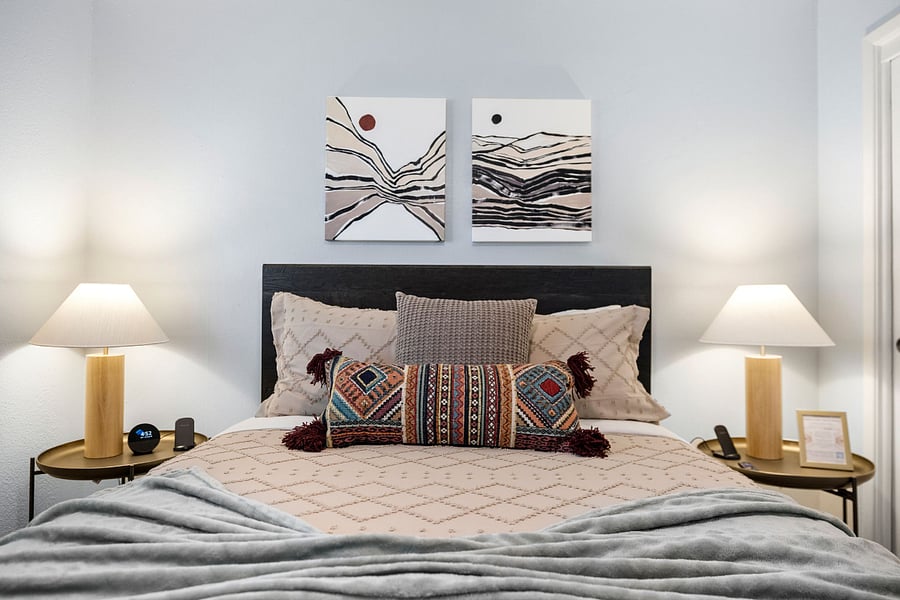 Enjoy deep rest on a premium Revive hybrid mattress, surrounded by warm lighting, soft textures, and calming tones. Perfect for guests who care about both comfort and design.