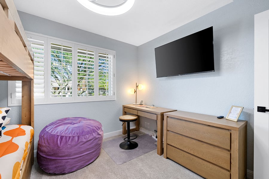 A fun and functional space featuring a twin-over-twin bunk bed and a hidden pull-out trundle (sleeps 3 total). Includes a smart TV, desk for homework or gaming, and a bean bag for lounging.