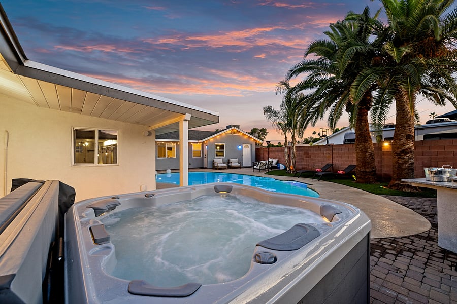 Soak under the stars in the private hot tub or unwind poolside surrounded by swaying palms  your backyard oasis awaits.