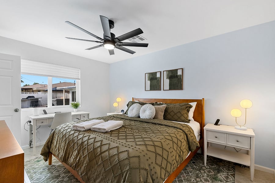 This quiet casita bedroom features a king bed with a high-end hybrid mattress, blackout shades, dedicated desk space, and a direct view of the pool.