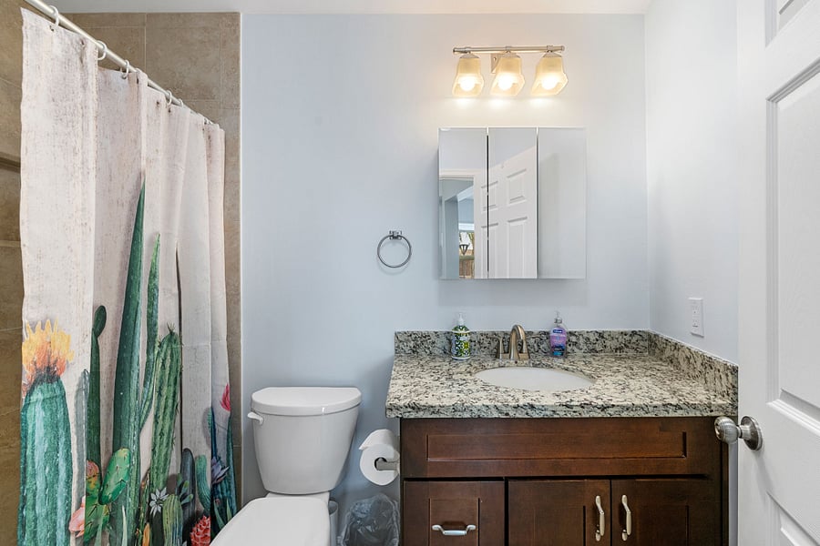The casita bathroom features a granite vanity, modern fixtures, and a walk in shower 