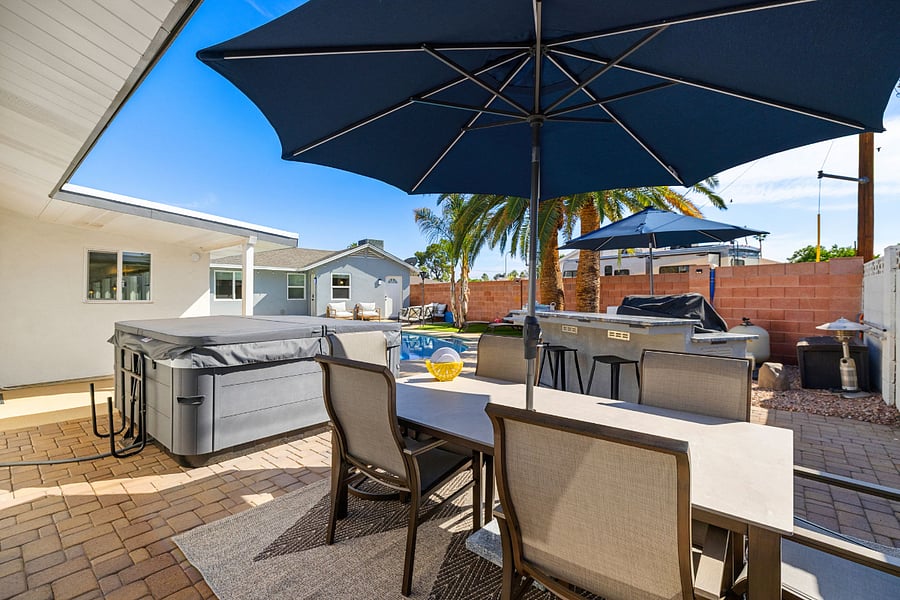 Grill, chill, and sip in style your own private outdoor kitchen & bar under the palms 