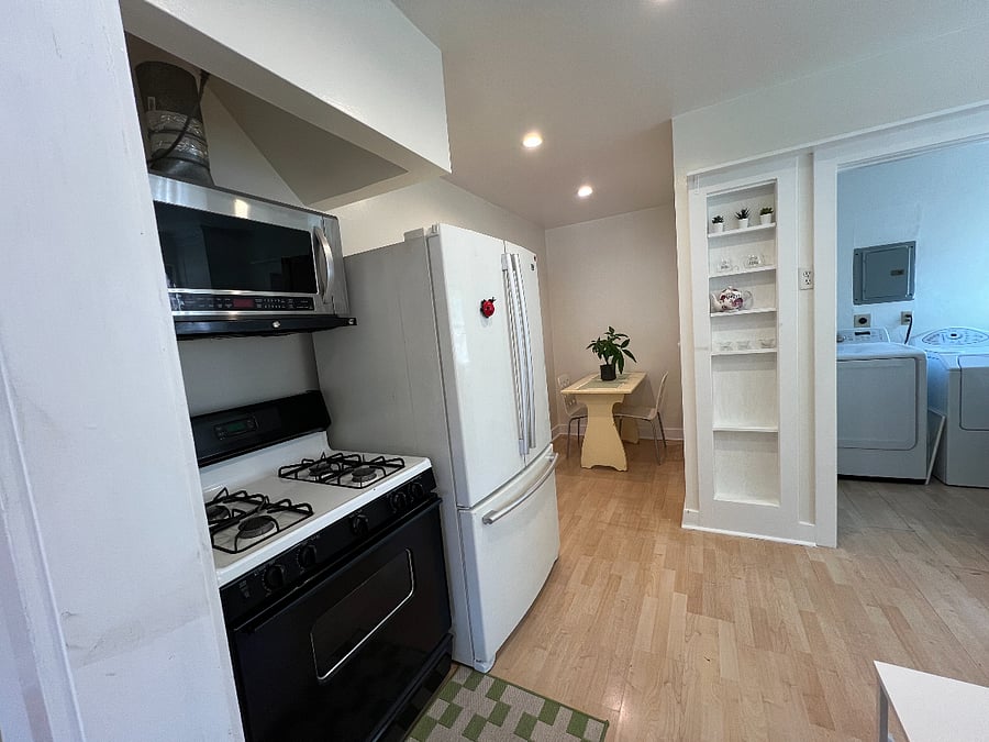 Kitchen with view of banquette and seperate Laundry room