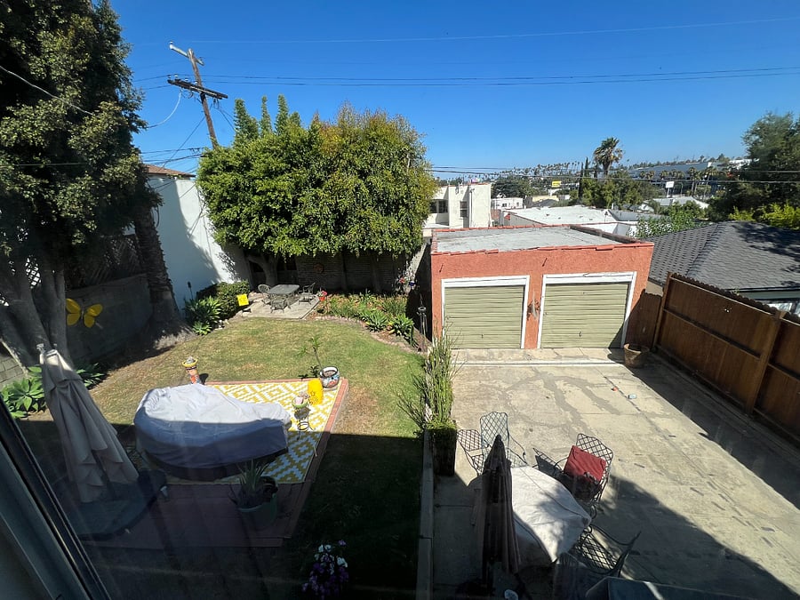 View from the Queen bedroom into the backyard.  Storage available in one garage.  