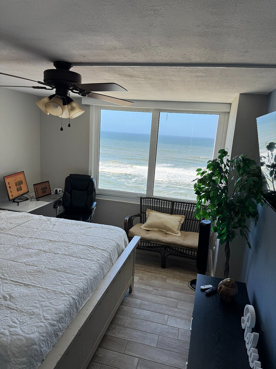 One of two bedrooms. Both have king size beds and a view of the ocean.. This room has a desk