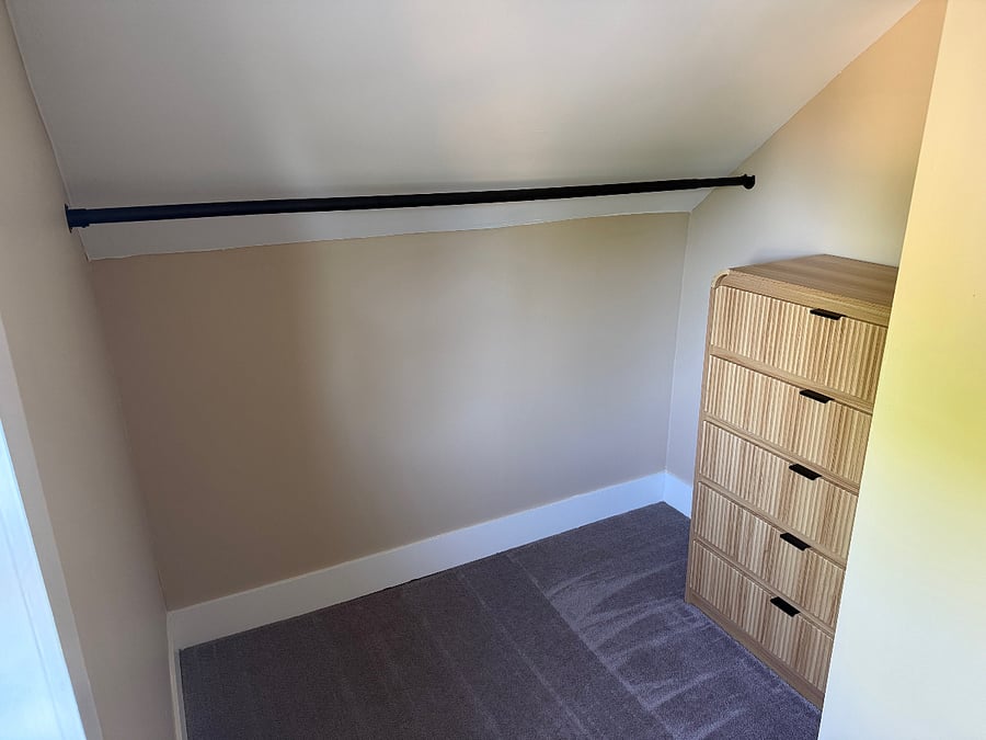 Walk-in closet with dresser