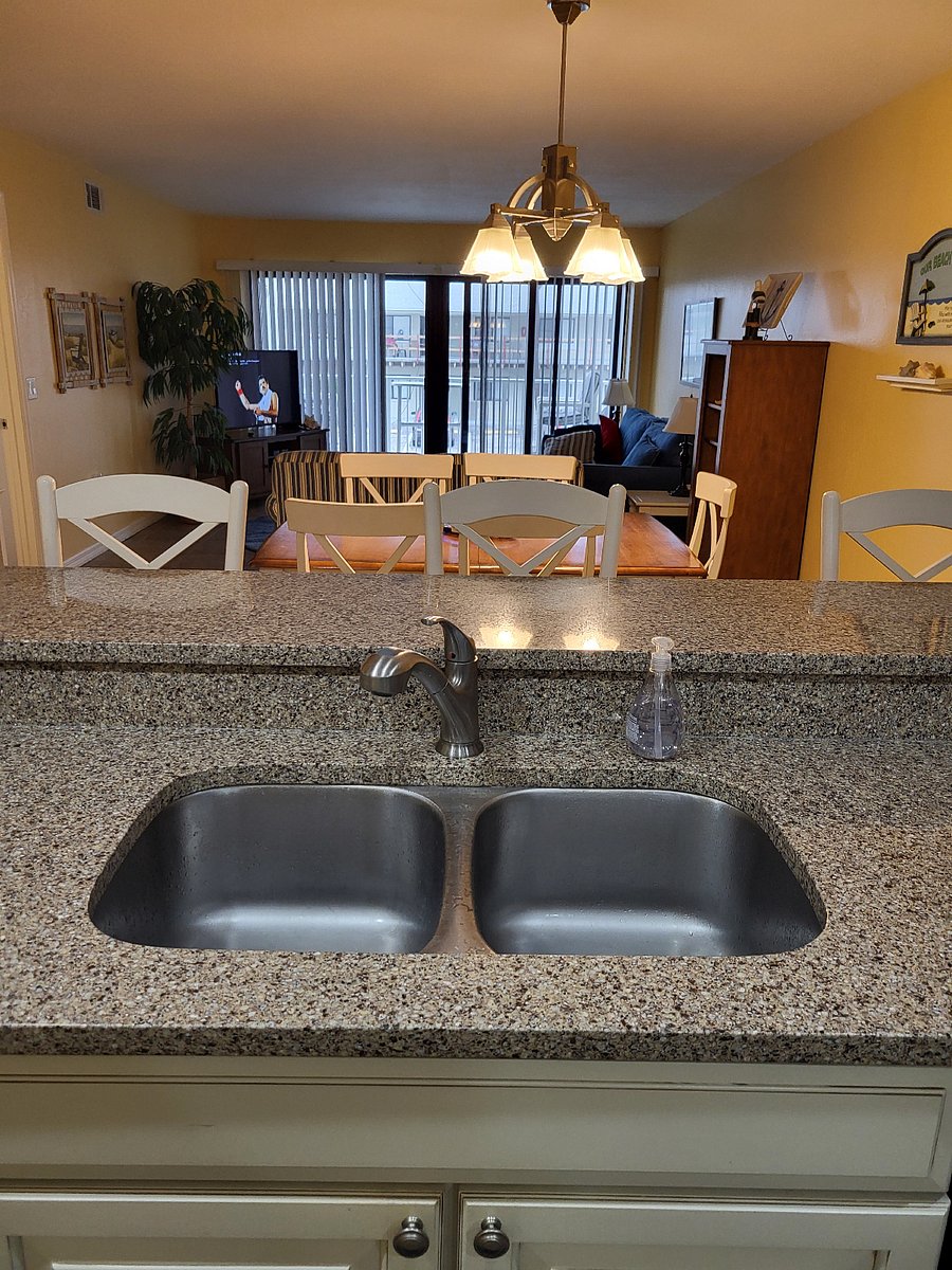 view from kitchen toward dining, living room and slider doors to balcony