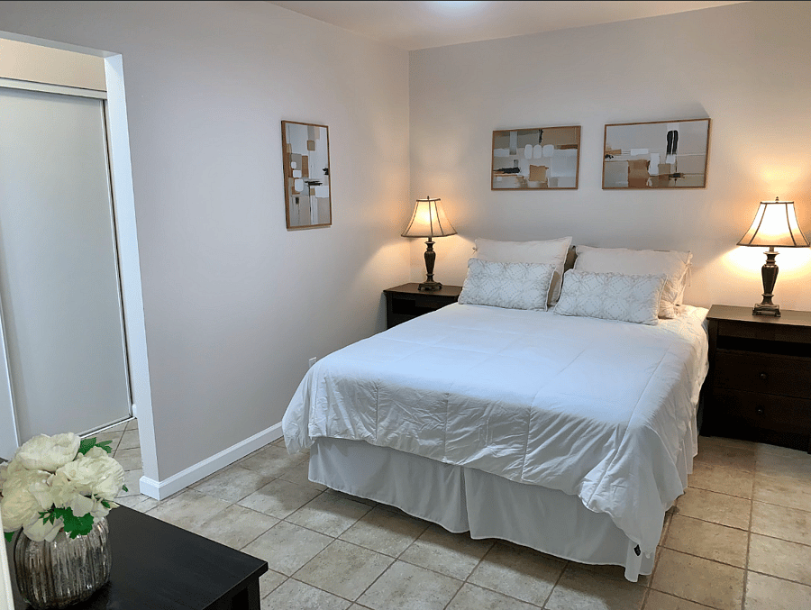 Bedroom 1 Enjoy a comfortable queen-size bed with clean linens, perfect for a restful nights sleep after a long day. Matching nightstands with drawers provide extra storage space for your personal items, keeping the room organized and clutter-free. Designed with both comfort and function in mind, this bedroom is ideal for extended stays