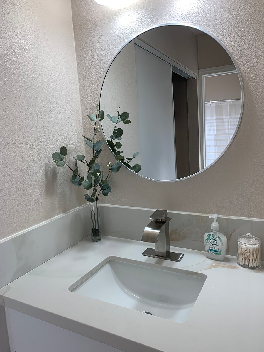 Bedroom 2 is complemented by new countertops and cabinetry, creating a modern, clean, and functional look that enhances both style and convenience.
