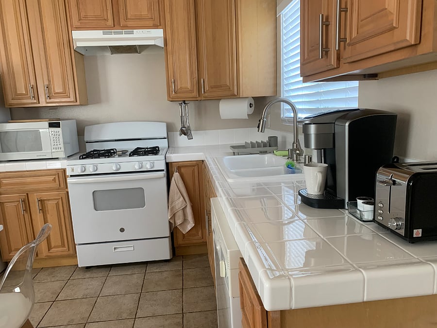 The kitchen includes a microwave, coffee maker, toaster, gas stove, and oven for your cooking convenience, along with a washer and dryer on the premises for easy laundry access.