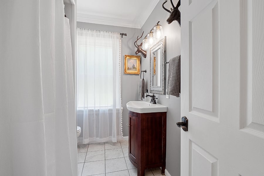 Upstairs bathroom. Tub shower with curtain rod. Requires step to get into shower or bath.