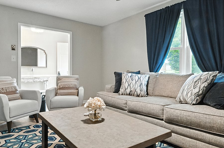 Pro Tip: Blackout curtains prevent glare on the TV, and cozy blankets can be found in the storage beneath the cushions of the chairs.