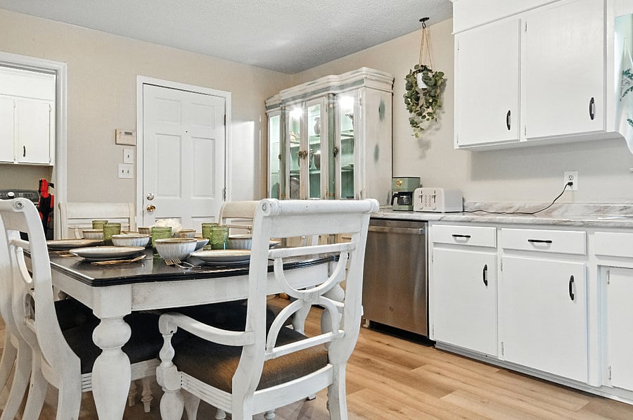 The kitchen table has an insert and two extra chairs, providing seating for up to 8 people.