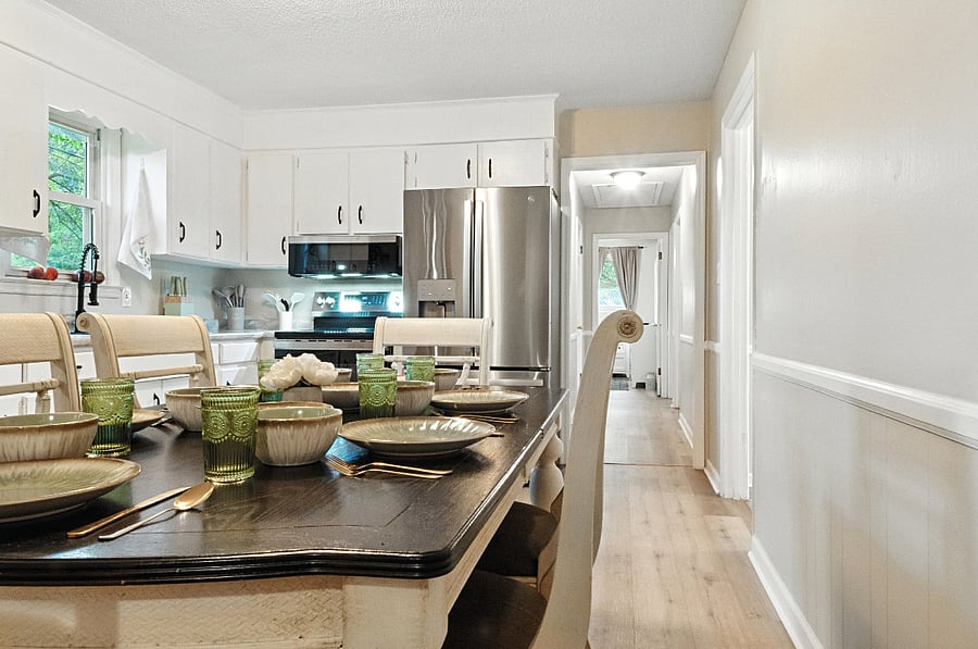 The calming kitchen has mint green and gold accents, including the tableware, cutlery and glasses for 8.