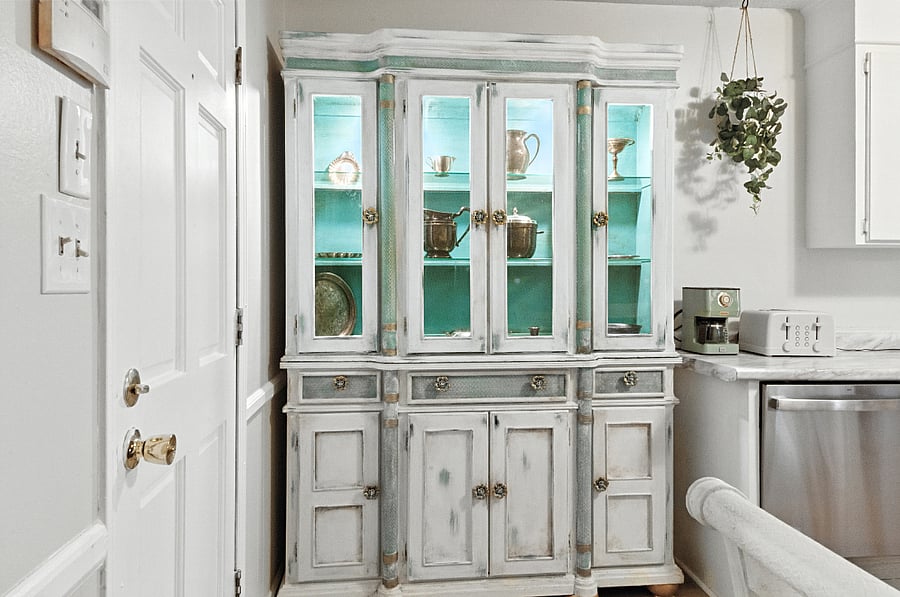 Many of the decorations throughout the house came from the basement when the house was purchased, including the silver displayed in this curio.