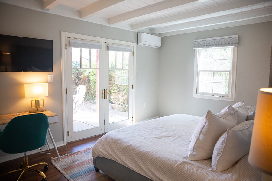 King bed, french doors looking to the backyard, TV and designated work station