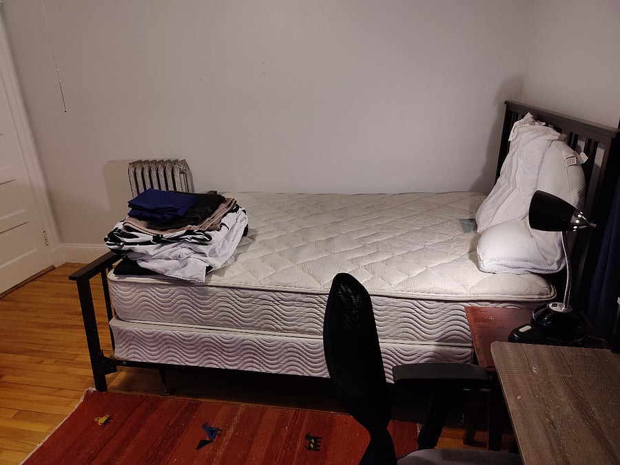 12'x12', Queen bed, armoire, walk-in closet with drawers and sink, desk and chair, side table, lamps.