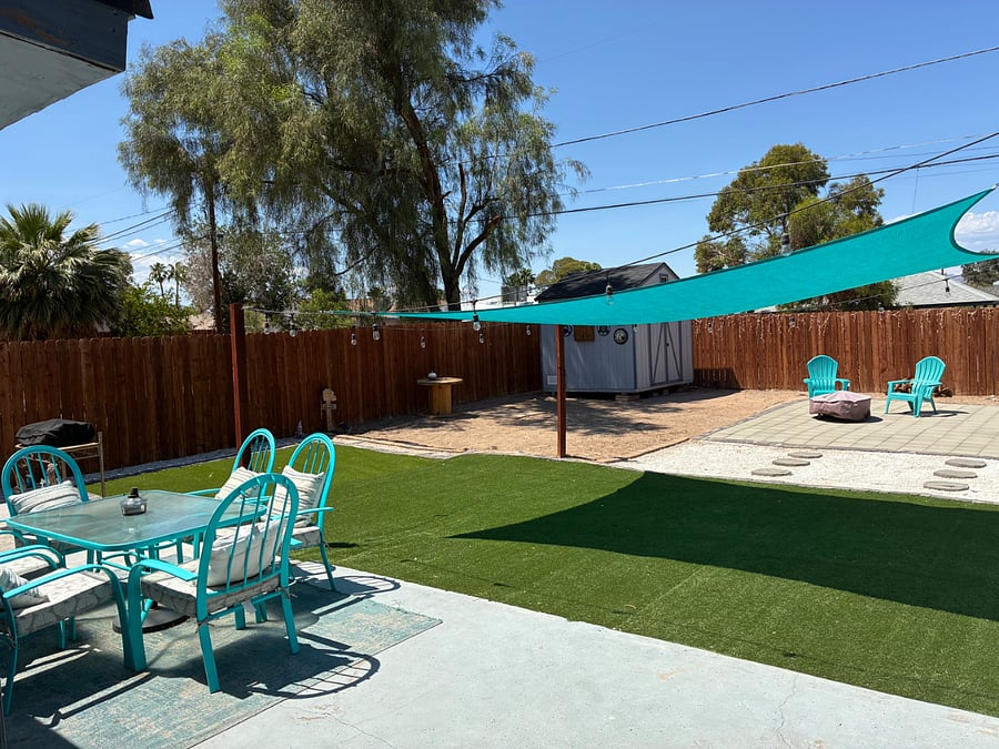 Immense backyard furnished with a 6 chair patio set.