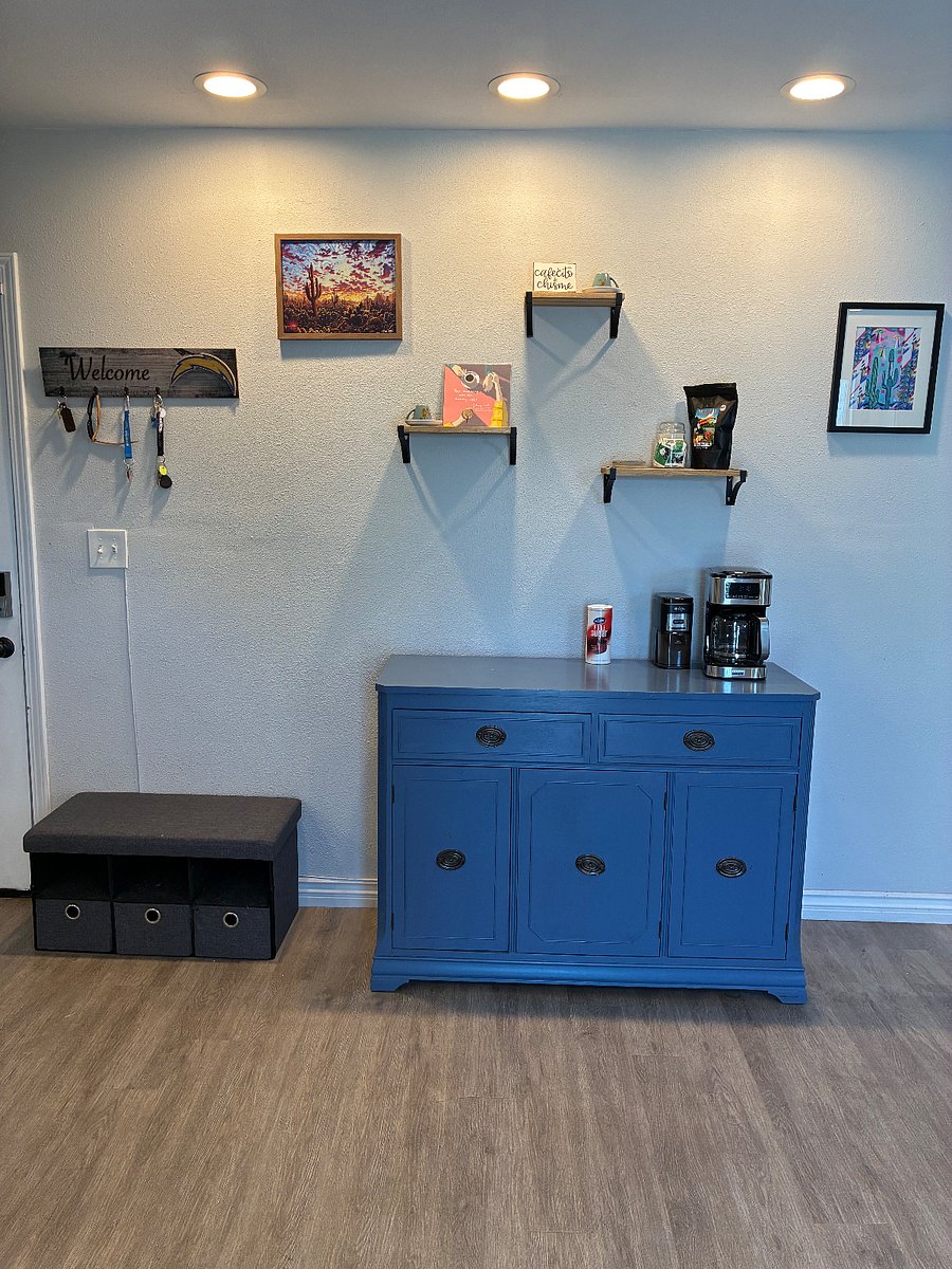 Coffee station stocked with a Coffee machine, coffee grinder, coffee, tea and mugs. 